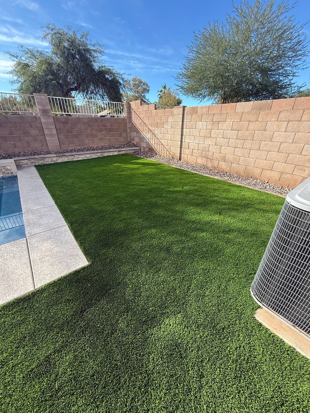 L-shaped outdoor kitchen with raised bar seating in Arizona